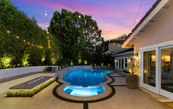 New Pool, Linear Stone Firepit & Porcelain Tile Night Photo