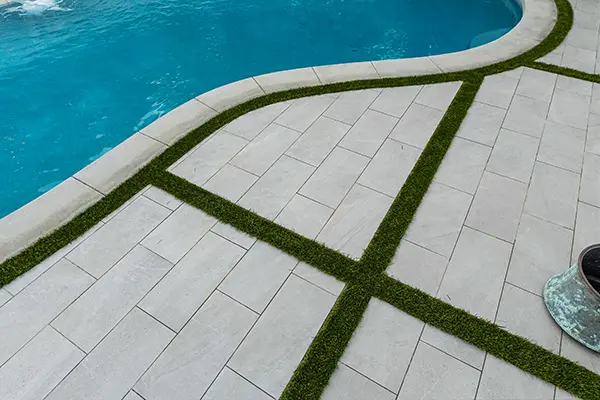 Porcelain Tile with Artificial Turf Between & Poured in Place Coping