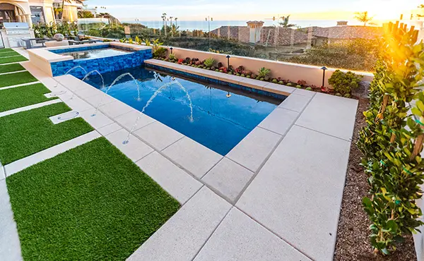 Pool with Poured Concrete Coping with Water Jets & Artificial Turf